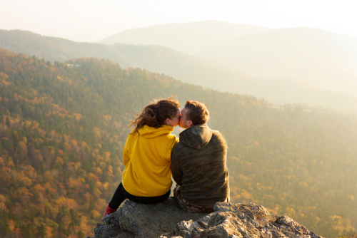 beautiful,couple,in,love,sitting,at,the,top,of,the